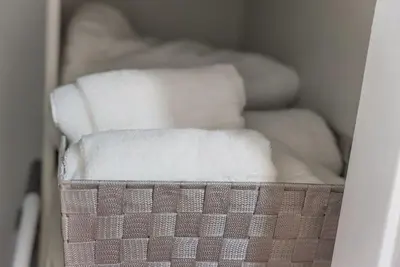 a bunch of white towels in a closet at Quiet 1- bedroom condo near LAX, SoFi, and the Beach in Los Angeles