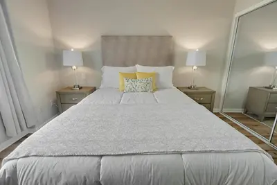 a bedroom with a large bed with two lamps at Quiet 1- bedroom condo near LAX, SoFi, and the Beach in Los Angeles