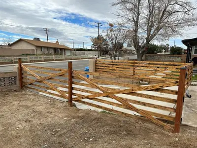 a wooden fence in front of a house at Desert Oasis Retreat in Barstow in Barstow