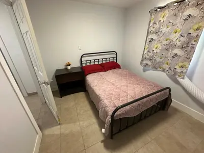 a small bedroom with a bed and a table at Desert Oasis Retreat in Barstow in Barstow