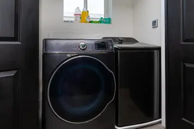 a black washer and dryer in a room at Spacious Luxury Villas in the heart of LA! Free parking and Jacuzzi in Los Angeles