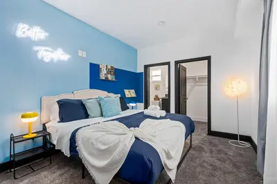 a blue and white bedroom with a large bed at Spacious Luxury Villas in the heart of LA! Free parking and Jacuzzi in Los Angeles