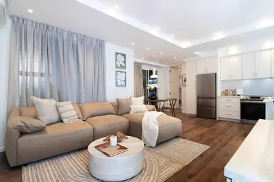 a large living room with a couch and a kitchen at Modern 2BR Oasis with BBQ Sauna & Private Yard in Los Angeles