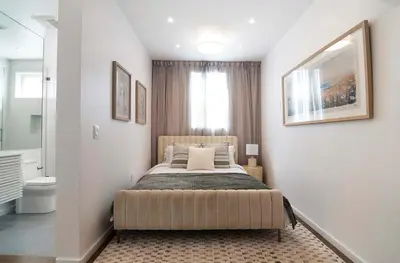 a bedroom with a large bed in a room at Modern 2BR Oasis with BBQ Sauna & Private Yard in Los Angeles