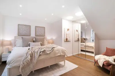 a white bedroom with a bed and a mirror at Modern 2BR Oasis with BBQ Sauna & Private Yard in Los Angeles