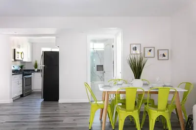 a dining room with a table and yellow chairs at Central 3BR Apt Near Americana in Glendale