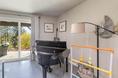 a living room with a piano in the corner at The Great Escape Beach Access, Near Slopes, View in Lake Arrowhead