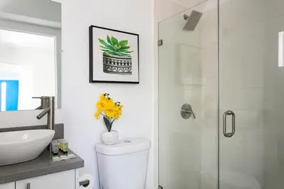 a bathroom with a toilet and a glass shower at Enjoy Stylish 4BR Townhouse Sleeps 8 with Wi-Fi in Los Angeles