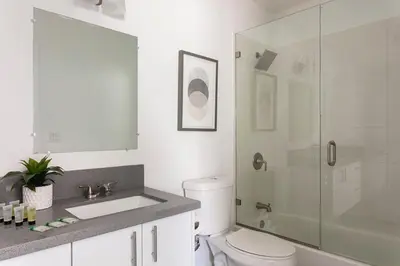 a bathroom with a toilet and a glass shower at Enjoy Stylish 4BR Townhouse Sleeps 8 with Wi-Fi in Los Angeles