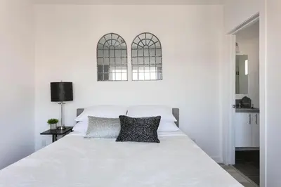 a white bed with two pillows on top of it at Experience Luxury 4BR Townhouse Sleeps 8 with Parking in Los Angeles