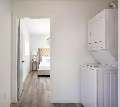 a white room with a bed and a kitchen at Experience Luxury 4BR Townhouse Sleeps 8 with Parking in Los Angeles