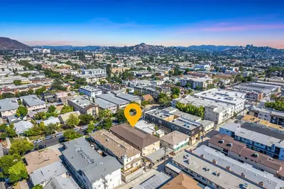 an overhead view of a city with buildings and a yellow arrow at Luxury 2BR Apartment Great Area with Parking in Glendale