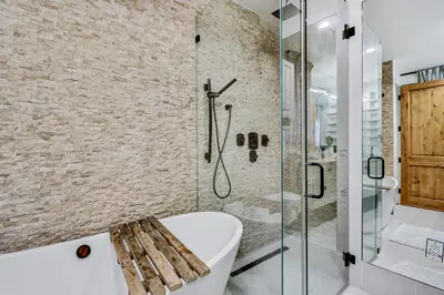 a bathroom with a tub and a glass shower at Modern LA Villa 5BR Home with Private Pool & Yard in Los Angeles