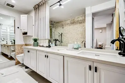 a white bathroom with a sink and a toilet at Modern LA Villa 5BR Home with Private Pool & Yard in Los Angeles