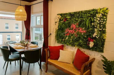 a dining room with a table and a flower wall at Ocean View Balcony, 4 Min Walk to Beach in Manhattan Beach