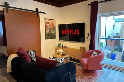 a living room with a television and two chairs at Ocean View Balcony, 4 Min Walk to Beach in Manhattan Beach
