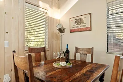 a dining room with a wooden table with wine glasses at Acorn Cottage in Big Bear Lake
