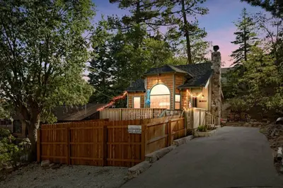 a house with a wooden fence and a gate at Acorn Cottage in Big Bear Lake