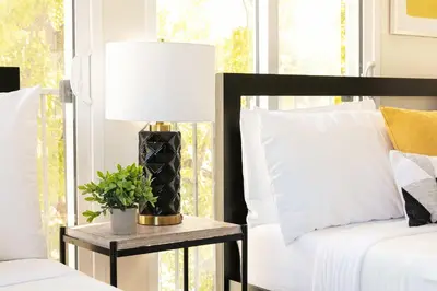 a bedroom with a bed and a table with a lamp at Unwind in Spacious 2BR Apt Sleeps 6 with Parking in Glendale