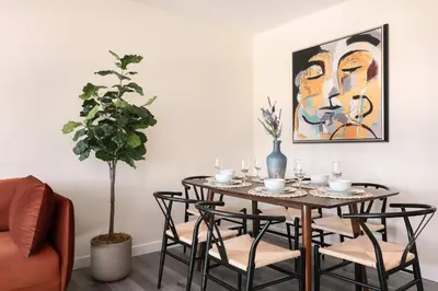 a dining room with a table with chairs and a painting at Unwind in Spacious 2BR Apt Sleeps 6 with Parking in Glendale