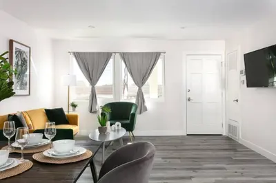 a living room with a table and chairs at Luxury 3BR Condo Near Americana and Galleria in Glendale
