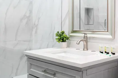 a white bathroom with a sink and a mirror at Modern 3BR Apt with Parking in Glendale in Glendale