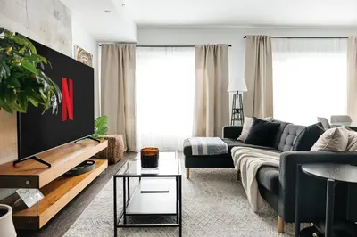 a living room with a couch and a tv at Luxury Spacious Studio in Los Angeles