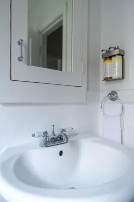 a white sink in a bathroom with a mirror at Furnished Studio in Hollywood in Los Angeles