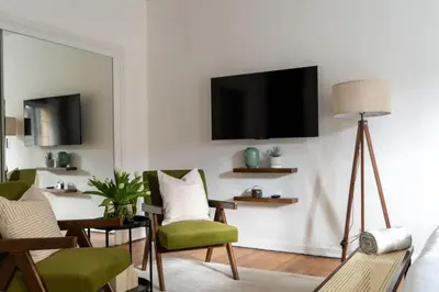 a living room with a tv on a wall at Furnished Studio in Hollywood in Los Angeles