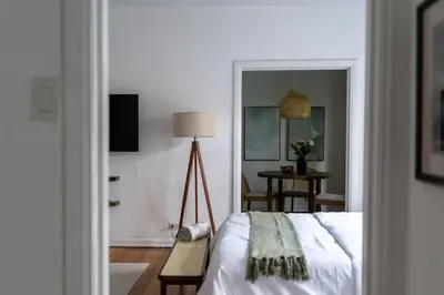a bedroom with a bed and a lamp and a table at Furnished Studio in Hollywood in Los Angeles