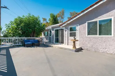 a house with two blue chairs on a patio at Spacious Family Retreat in San Dimas Great Location in Covina