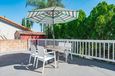 a table and chairs with an umbrella on a patio at Spacious Family Retreat in San Dimas Great Location in Covina