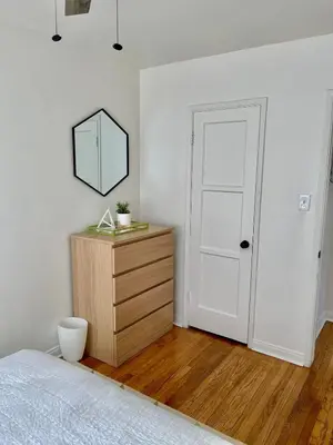 a bedroom with a bed and a dresser and a mirror at Remodeled Bixby Knolls 2 bedroom unit - Close to shopping in Long Beach