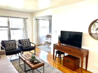 a living room with a flat screen tv and a piano at Remodeled Bixby Knolls 2 bedroom unit - Close to shopping in Long Beach