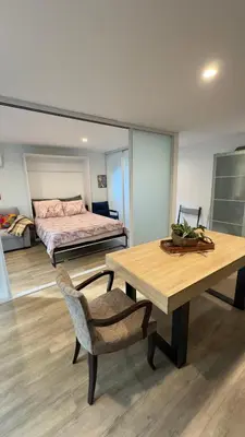 a bedroom with a bed and a table and a bed at Joyful Place in Sherman Oaks