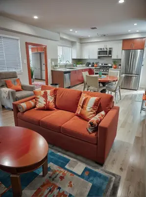 a living room with a couch and a kitchen at Stay in Style Hollywood Residences with Free Parking in Los Angeles