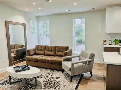 a living room with a couch and a table at Stay in Style Hollywood Residences with Free Parking in Los Angeles