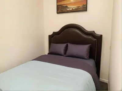 a bed with a brown headboard in a room at Stylish Venice Escape Near the Marina & Beachfront in Los Angeles