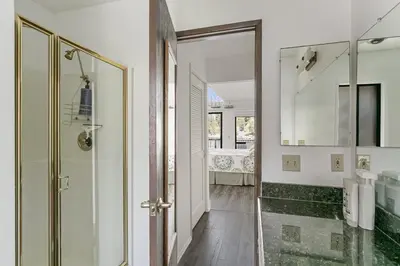 a bathroom with a shower and a glass door at Lakeside Comfort condo in Lake Arrowhead