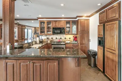 a large kitchen with wooden cabinets and granite counter tops at Lakeside Comfort condo in Lake Arrowhead