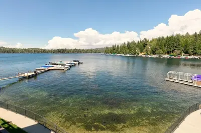 a view of a lake with boats in the water at Lakeside Comfort condo in Lake Arrowhead