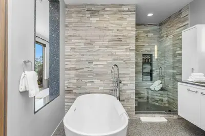 a bathroom with a white toilet and a shower at Chateau Lumier by Stay Awhile in Los Angeles