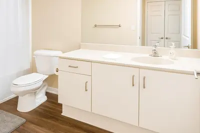 a white bathroom with a toilet and a sink at Cozy Home Close to Disney in Orange