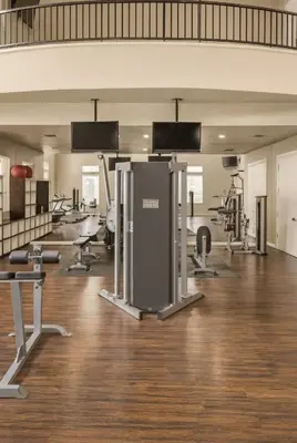 an empty gym with a large room with machines at Cozy Home Close to Disney in Orange