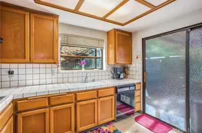 a kitchen with a sink and a glass shower at Spacious Fully Furnished 3BR Fully Fenced Home in Riverside