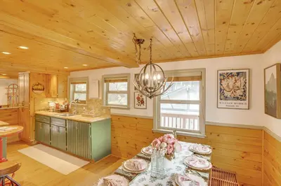 a kitchen with a table with flowers on it at 3 Mi to Snow Summit Charming Home with Fenced Yard in Big Bear Lake
