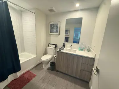 a bathroom with a toilet and a sink and a tub at 3 bedroom Home Casa Serenity Central Los Angeles in Los Angeles