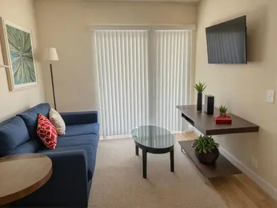 a living room with a blue couch and a table at 3 bedroom Home Casa Serenity Central Los Angeles in Los Angeles