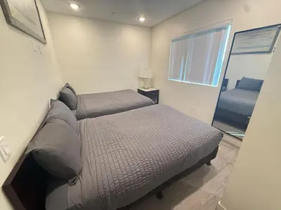 a small bedroom with a bed and a mirror at 3 bedroom Home Casa Serenity Central Los Angeles in Los Angeles