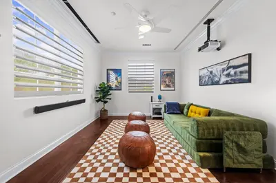 a living room with a couch and a ottoman at Modern Hilltop Retreat in Lakeside Park